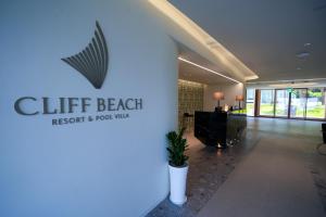 a lobby of a hotel with a sign that reads cliff beach resort and rooms at 클리프비치 in Sangun-ni