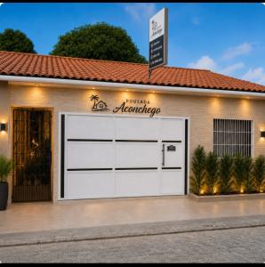 a white garage door with a sign on it at Hospedagem Aconchego Do Lar in Barreirinhas