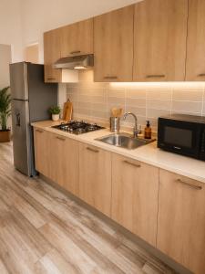 a kitchen with a sink and a refrigerator at Paraiso Destiny E2 in Bayahibe
