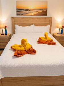 two rubber ducks are sitting on a bed at Paraiso Destiny E2 in Bayahibe