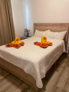 two stuffed animals sitting on top of a bed at Paraiso Destiny E2 in Bayahibe