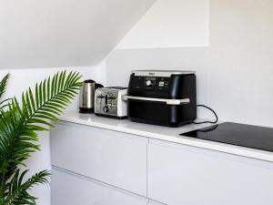 a kitchen counter with a microwave and a toaster at Charlettes Lodge in Cobh