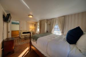a bedroom with a large bed and a living room at Downtown Four Poster Piedmont in Eureka Springs