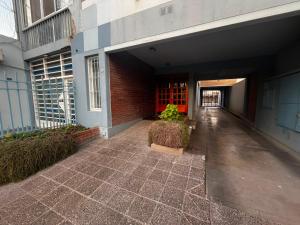 an empty hallway of a building with a brick wall at Departamento Las Golondrinas in Estación Coronel Maldonado