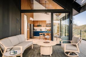 a living room with a couch and a table at Lakay Monteverde with Heated Pool, Golf Cart, Breakfast in Monteverde Costa Rica