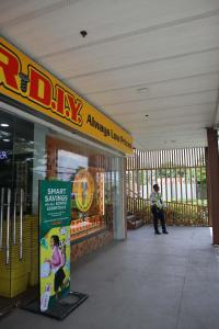 a woman standing in front of a store at Yangs Homeey Place2 in Bankal +1 photo