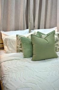 a bed with a bunch of pillows on it at Dover View Villas in Carriacou +8 photos