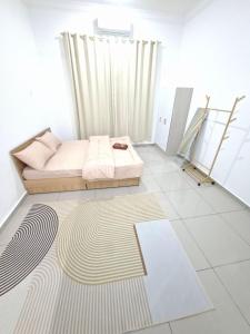 a room with a bed and a rug on the floor at D'Biru Homestay Segamat in Segamat