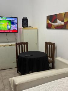 a dining room with a table and a tv at Los Romanos farm in Sauce Bajada