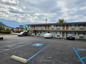 a building with cars parked in a parking lot at San Luis Inn and Suites in San Luis Obispo