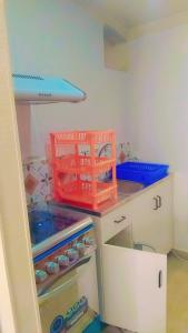 a kitchen with a counter with a red basket on it at Riverside Holiday Arartment in Sigatoka +5 photos