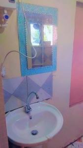 a bathroom with a sink and a mirror and a mirror at Riverside Holiday Arartment in Sigatoka