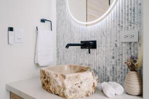 a bathroom with a stone sink and a mirror at Lakay Monteverde with Heated Pool, Golf Cart, Breakfast in Monteverde Costa Rica +108 photos