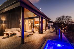 a house with a swimming pool on a wooden deck at Lakay Monteverde with Heated Pool, Golf Cart, Breakfast in Monteverde Costa Rica