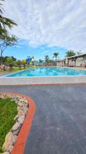 a large swimming pool with a water slide at on and on haus in Ban Na Nian