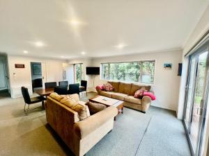 a large living room with two couches and a table at Pohara Retreat in Pohara
