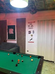 a pool table with balls on it in a room at Valle Encantado in Pantoja