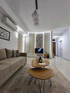 a living room with a couch and a table at Aura apartment in Petrovec +10 photos