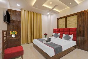 a bedroom with a large bed and a red headboard at Townhouse Hotel Spotlight in Nawābganj
