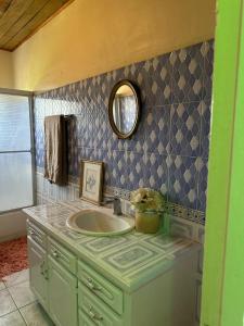 a bathroom with a sink and a mirror at Keisha's luxury stays in Santa Cruz
