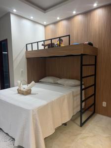 a bedroom with a bunk bed with a white table at Ilha Bela Flat Alter do Chão in Santarém +32 photos