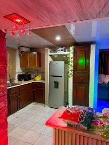 a kitchen with a refrigerator and a table in it at Valle Encantado in Pantoja +15 photos