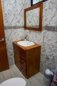 a bathroom with a sink and a mirror at Fernando's Bungalow in Puerto Ayora +19 photos