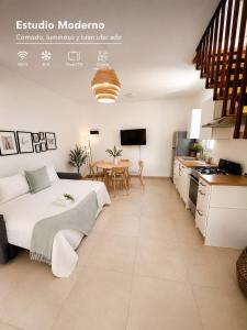 a bedroom with a bed and a kitchen with a table at Paraiso Destiny Duplex in Bayahibe