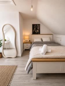 a bedroom with a bed and a large mirror at Charlettes Lodge in Cobh