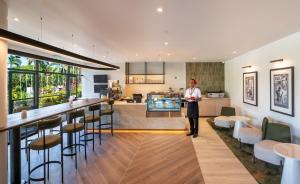 a man standing in the kitchen of a house at Tanoa International Hotel in Nadi +30 photos