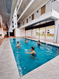 a group of children swimming in a swimming pool at monoambiente manu in Trinidad