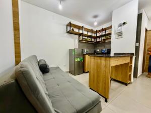 a living room with a couch and a counter at monoambiente manu in Trinidad