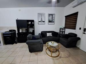 a living room with couches and a coffee table at The terrazzo house in Santa Ana