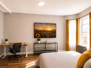 a bedroom with a bed and a desk and a painting of a sunflower at Journal Sq PATH - Private Queen Room - Private Bath - Shared Kitchen - 15 Min to NYC in Jersey City