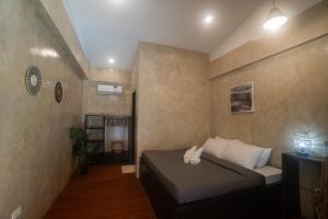 a bedroom with a bed in a room at Azarria Siargao Villas in General Luna +2 photos