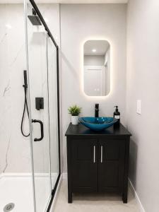 a bathroom with a sink and a glass shower at Journal Sq PATH - Private Queen Room - Private Bath - Shared Kitchen - 15 Min to NYC in Jersey City +8 photos