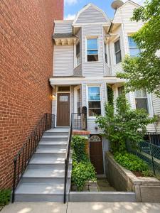 a white house with a staircase leading to the front door at Journal Sq PATH - Private Queen Room - Private Bath - Shared Kitchen - 15 Min to NYC in Jersey City