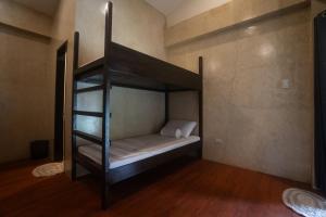 a bunk bed in a room with a ladder at Azarria Siargao Villas in General Luna
