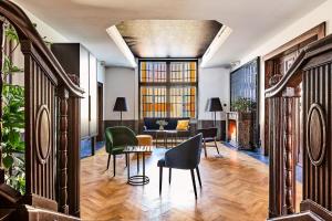 a living room with chairs and a table at Liberté 33, an Ascend Collection Hotel in Poznań