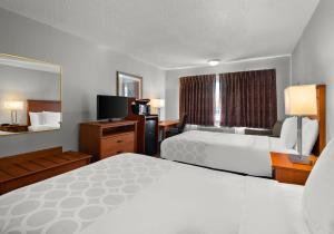 a hotel room with two beds and a television at Park Inn by Radisson, Detroit Metro Airport in Romulus