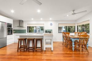a kitchen and dining room with a table and chairs at Stockton Coastal Escape in Stockton