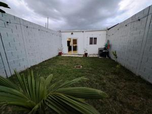 a white building with a yard in front of it at The terrazzo house in Santa Ana