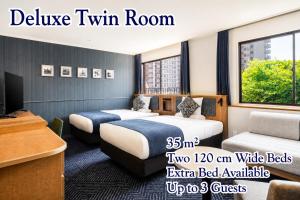 a hotel room with two beds and a tv at ART HOTEL Sasebo Central in Sasebo