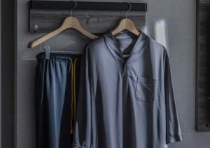 a coat and trousers are hanging on a rack at Super Hotel Yokkaichi Route 1 in Yokkaichi +76 photos