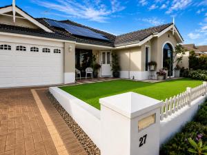 a house with a yard of green grass at Homestay in Coogee