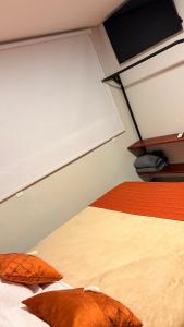 a room with two beds with orange pillows on it at Pousada Veredas da Canastra in Delfinópolis +39 photos