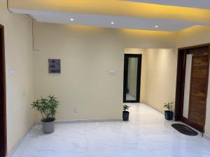 a hallway with two potted plants in a building at Residence MBK Studio 1 in Ziguinchor