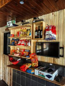 a room with a tv and a shelf with food at Kombi do Scooby-Doo in Mairiporã