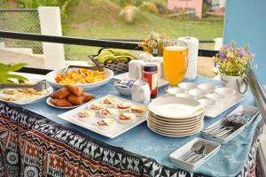 a blue table with food and plates on it at Save's Homestay in Nadi