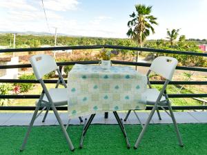 a table and two chairs on a balcony at Save's Homestay in Nadi +41 photos